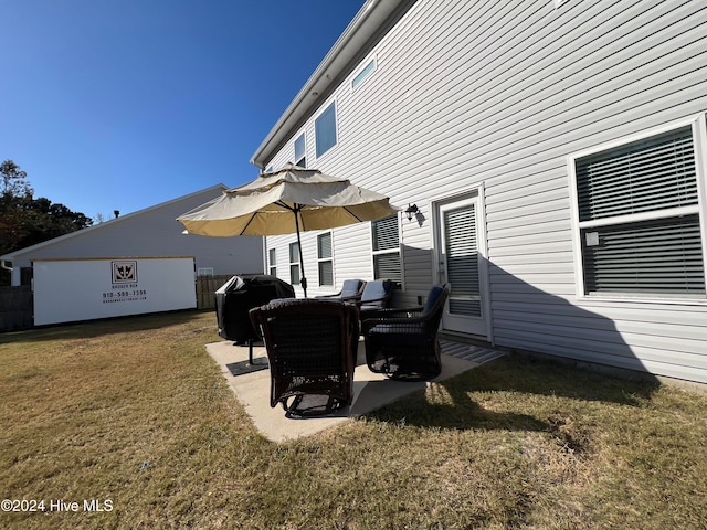 back of property featuring a yard and a patio