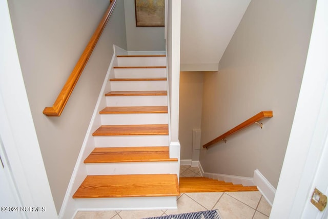 stairway featuring tile patterned flooring