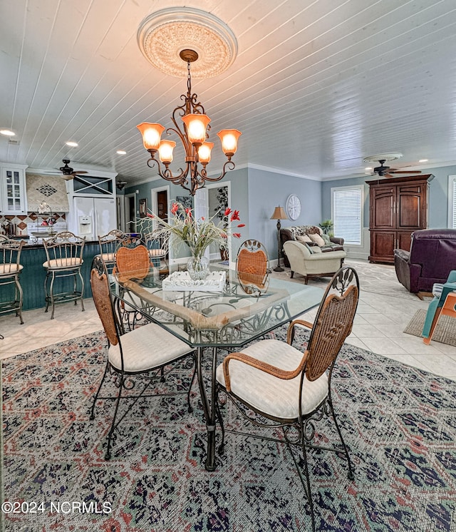 dining room with light tile patterned floors, ornamental molding, ceiling fan with notable chandelier, and wooden ceiling