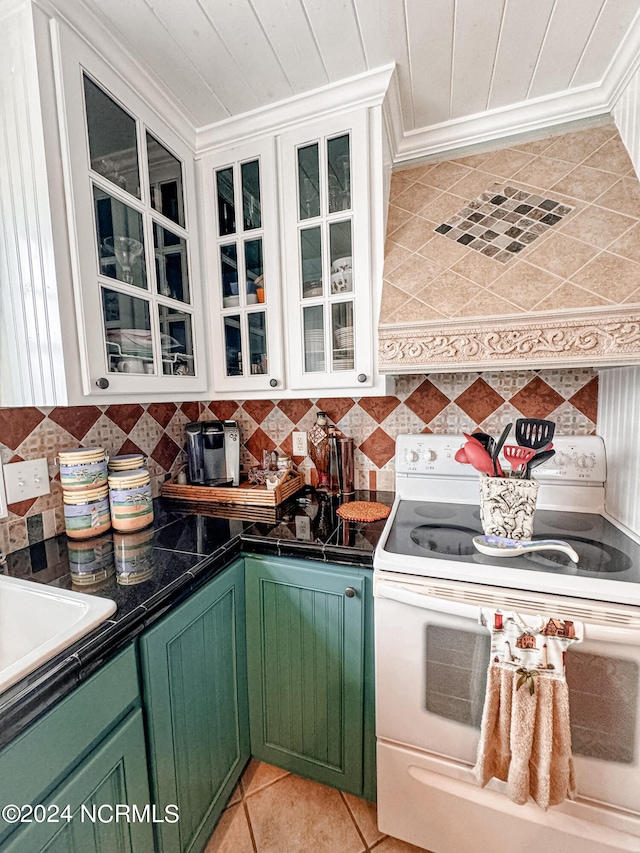 kitchen with light tile patterned flooring, white cabinetry, ornamental molding, electric range, and green cabinetry