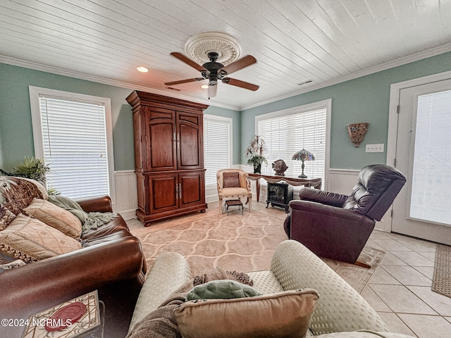 living room with crown molding, light tile patterned floors, and ceiling fan