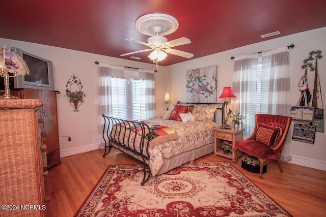 bedroom with light hardwood / wood-style floors and ceiling fan