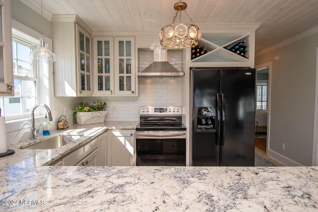 kitchen featuring black fridge with ice dispenser, sink, stainless steel electric range oven, pendant lighting, and wall chimney range hood