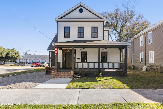 view of front of house with a porch and a front yard