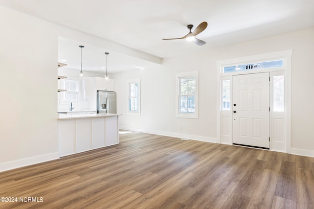 entrance foyer with ceiling fan, sink, and wood-type flooring