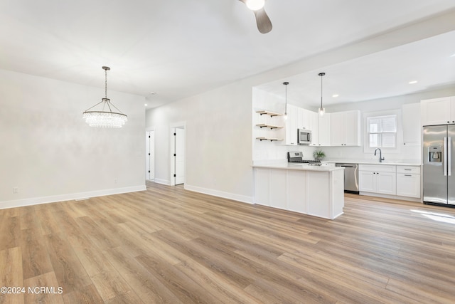 kitchen featuring sink, stainless steel appliances, white cabinetry, and light hardwood / wood-style flooring