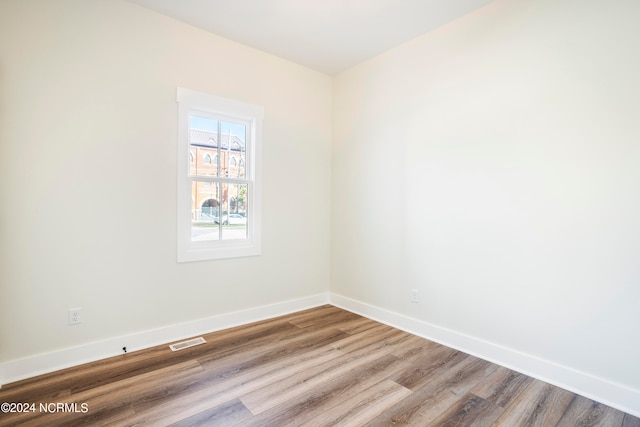 empty room with hardwood / wood-style floors