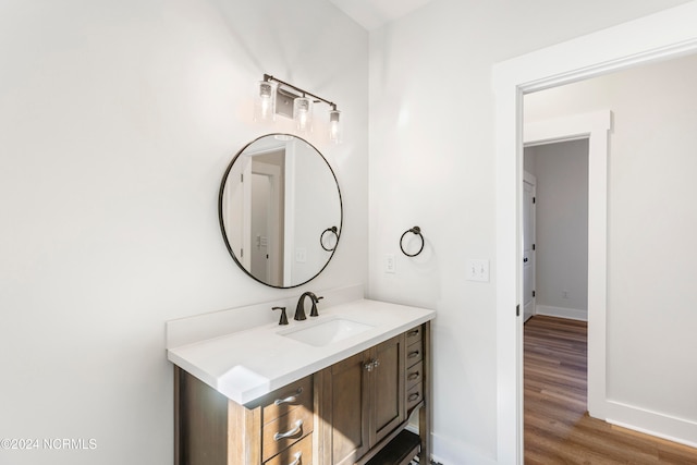 bathroom with hardwood / wood-style flooring and vanity