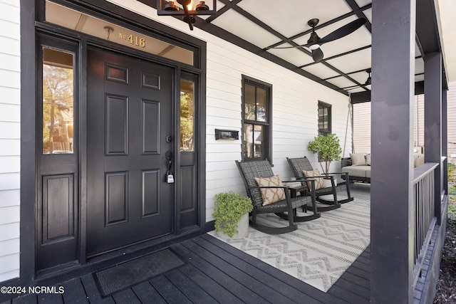 property entrance featuring a porch and ceiling fan