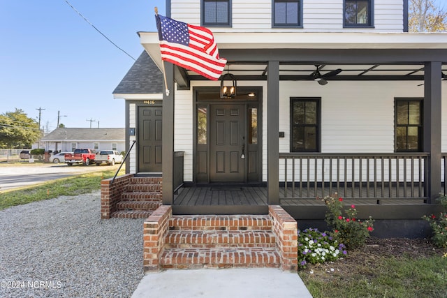 doorway to property with a porch and ceiling fan