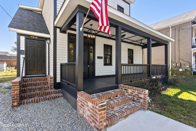 view of exterior entry with covered porch