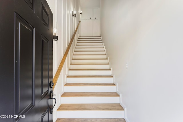 stairs featuring wood-type flooring