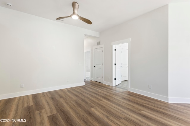 empty room featuring ceiling fan and dark hardwood / wood-style floors