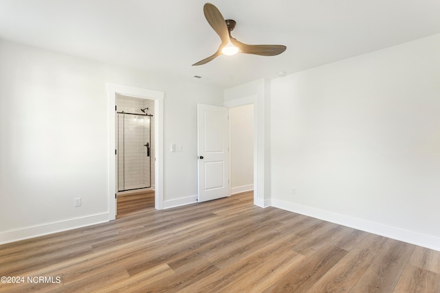 unfurnished bedroom with ceiling fan, light hardwood / wood-style floors, and ensuite bath