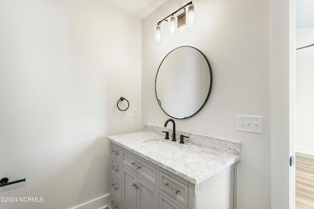 bathroom with vanity and hardwood / wood-style flooring