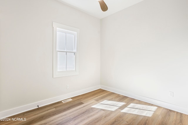 unfurnished room with hardwood / wood-style floors and ceiling fan