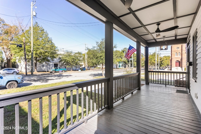 wooden terrace featuring ceiling fan and a porch