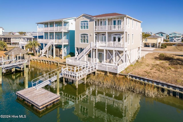 view of dock with a water view and a balcony