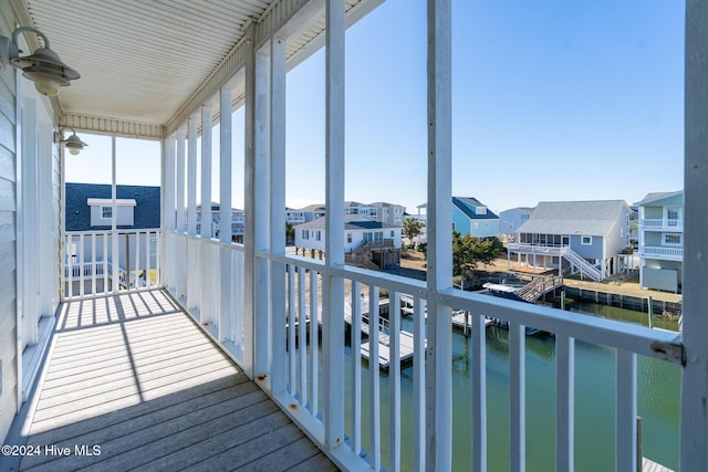 sunroom featuring a water view