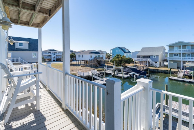 balcony with a boat dock and a water view