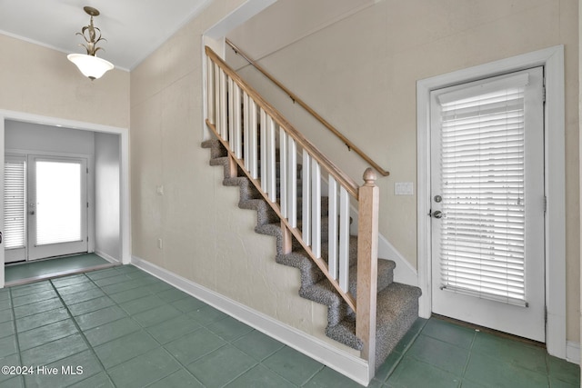 entrance foyer with dark tile patterned floors