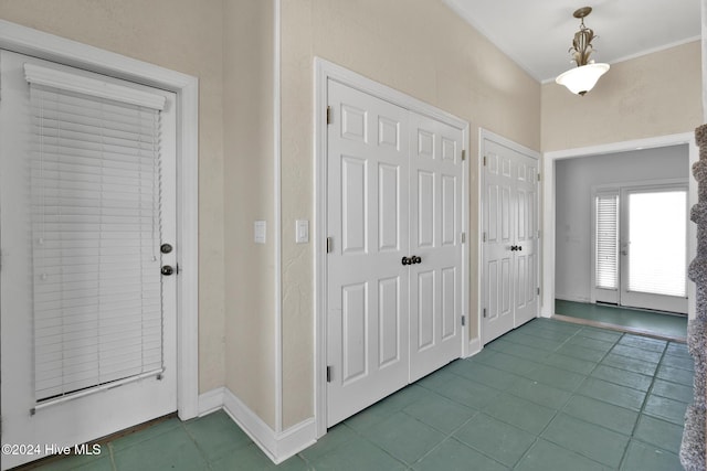 entrance foyer featuring tile patterned flooring and ornamental molding