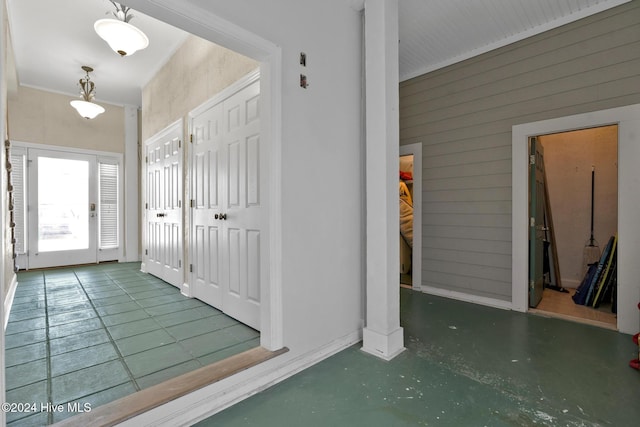 interior space with concrete floors and wooden walls