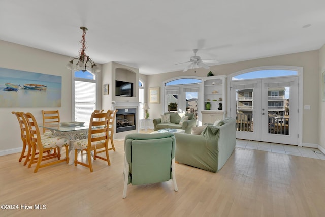 living room with ceiling fan, light wood-type flooring, and french doors