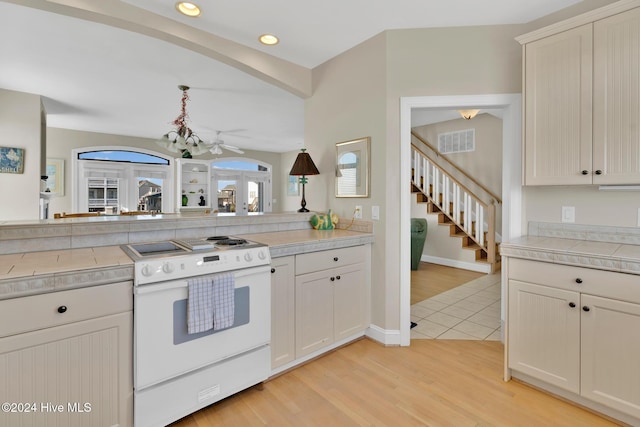 kitchen with light hardwood / wood-style floors, white electric stove, and ceiling fan