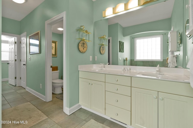 bathroom featuring tile patterned floors, vanity, and toilet