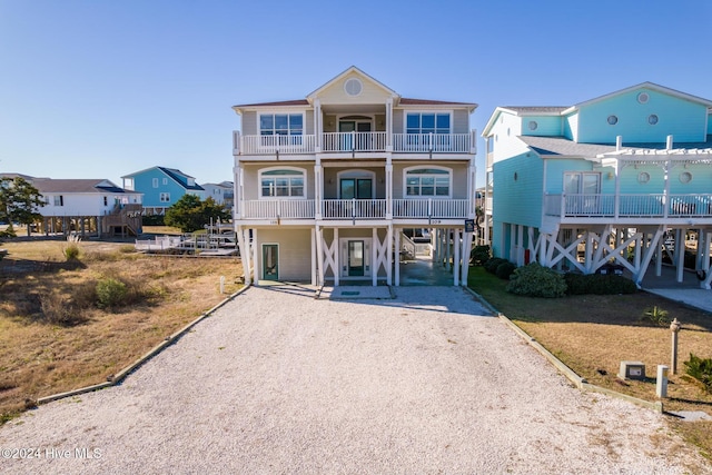 view of front of home with a balcony and a carport