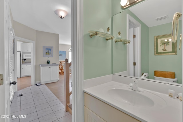 bathroom with tile patterned floors and vanity