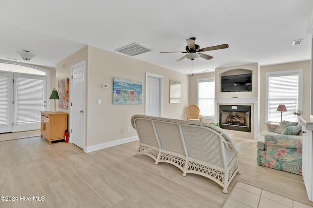 living room with ceiling fan and light wood-type flooring