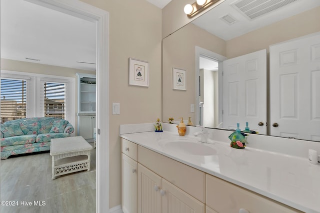 bathroom featuring hardwood / wood-style flooring and vanity