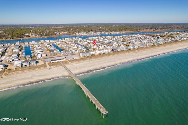 bird's eye view featuring a water view and a beach view