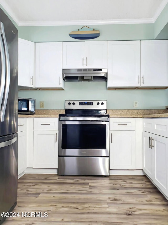 kitchen with stainless steel appliances, light hardwood / wood-style floors, and white cabinetry