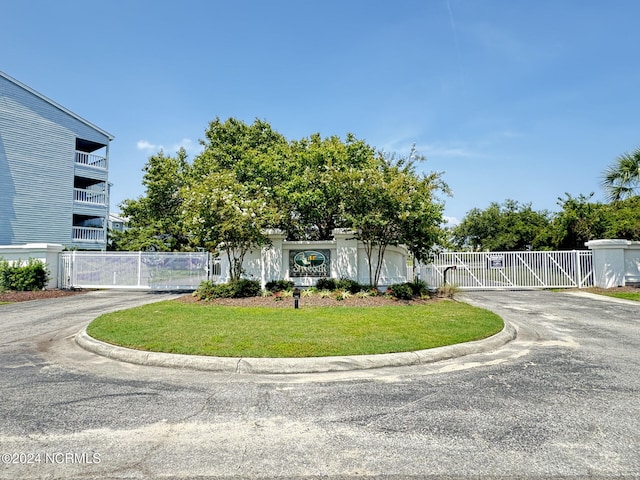 view of front facade with a balcony and a front lawn