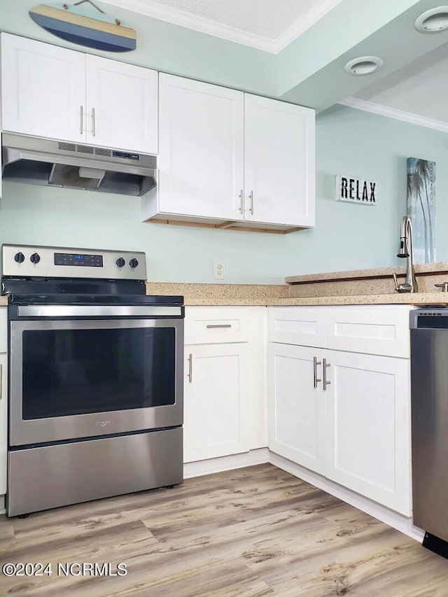 kitchen with light hardwood / wood-style floors, crown molding, white cabinetry, and stainless steel appliances