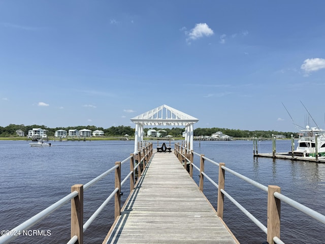 dock area with a gazebo and a water view