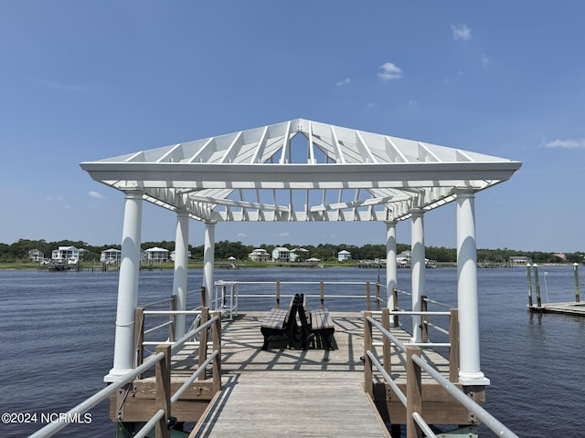 dock area featuring a water view and a pergola