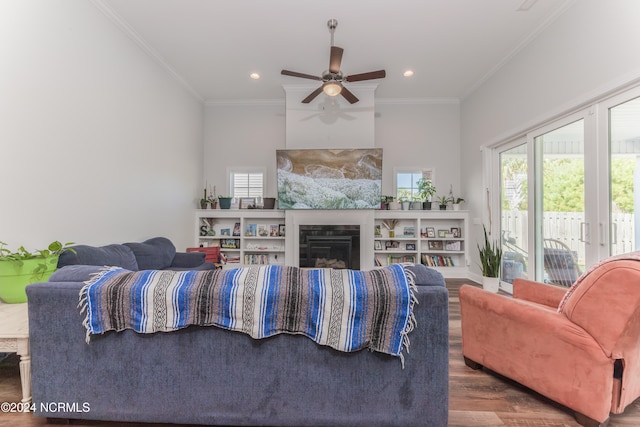 living room featuring crown molding, hardwood / wood-style flooring, and ceiling fan