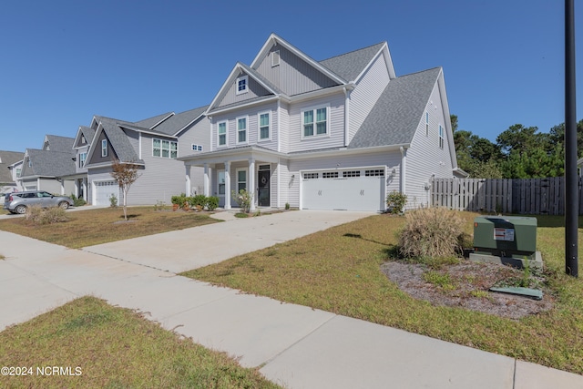 view of front of property with a garage and a front lawn