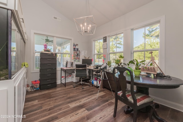 home office with dark wood-type flooring, a notable chandelier, lofted ceiling, and plenty of natural light