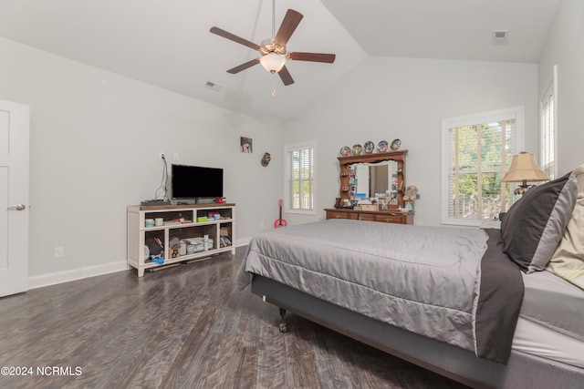 bedroom featuring ceiling fan, multiple windows, vaulted ceiling, and dark hardwood / wood-style floors