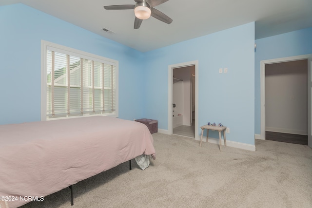 carpeted bedroom featuring a spacious closet, ceiling fan, and a closet