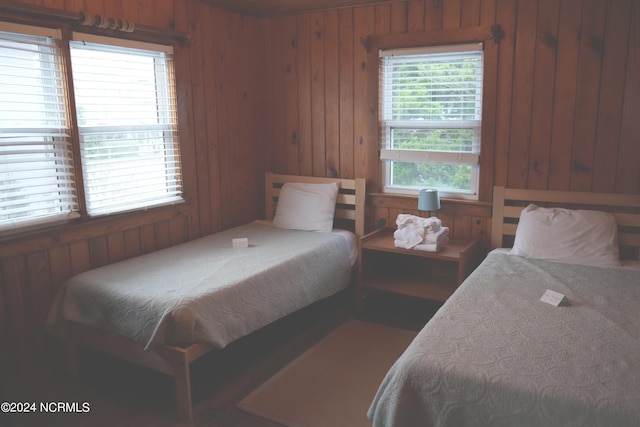 bedroom featuring wood walls