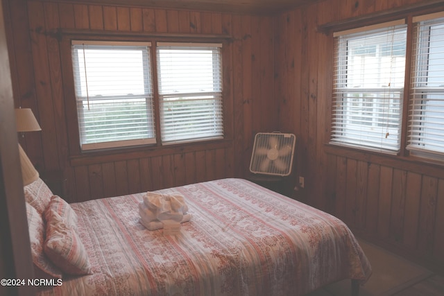 bedroom with wood walls