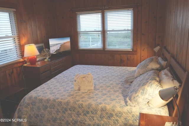 bedroom featuring wooden walls