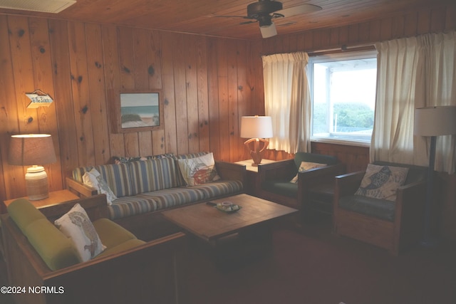 living room featuring wooden walls, ceiling fan, and wood ceiling