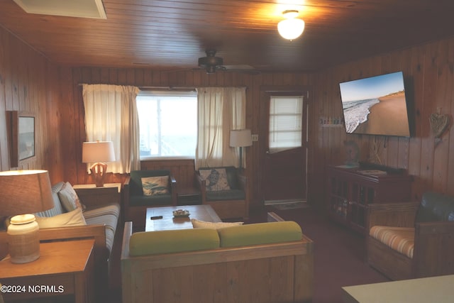 living room featuring wood ceiling, wooden walls, and ceiling fan